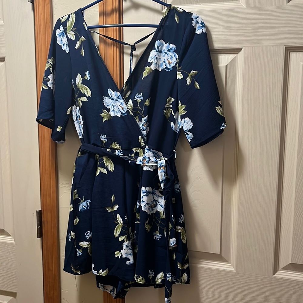 Navy blue romper with tie detail around waist and in back. Womens size small.
